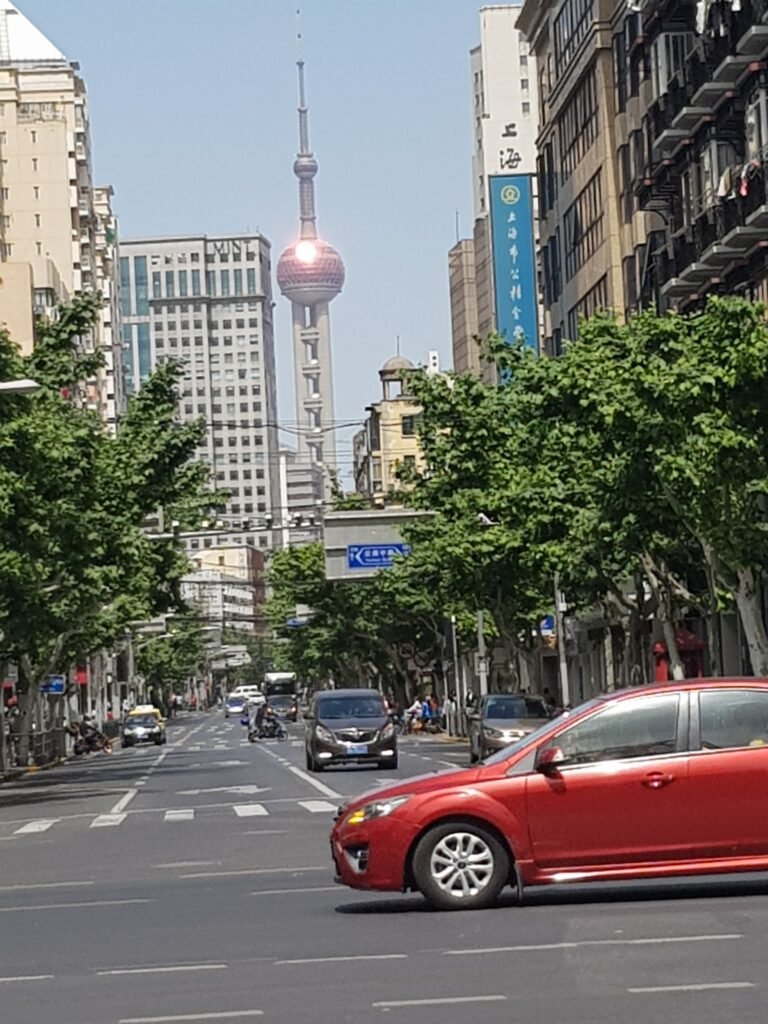 Street view photo taken in Shanghai looking towards the Oriental Pearl Tower