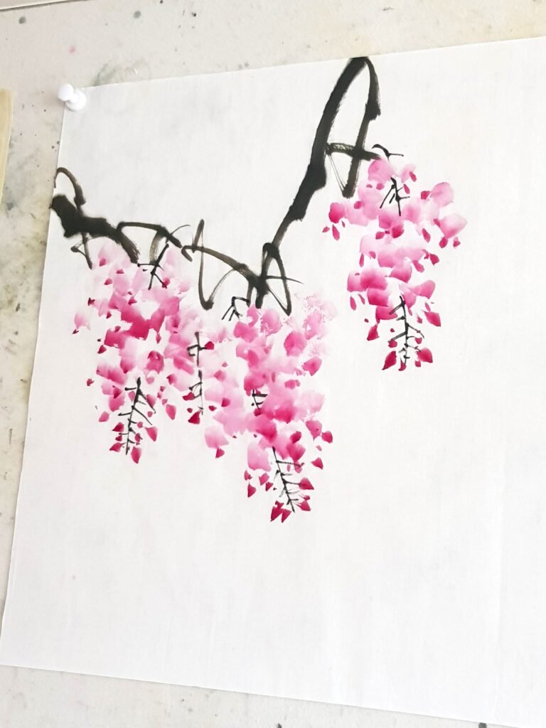 Three pink wisteria racines painted in a loose style on white paper