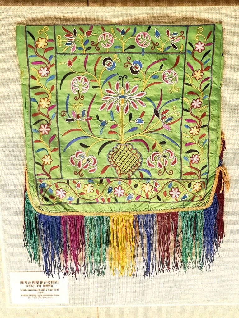 A multi-coloured floral embroidered light green Uygur scarf with multi-coloured fringe from Kashgar, made in the first half of the 20th century