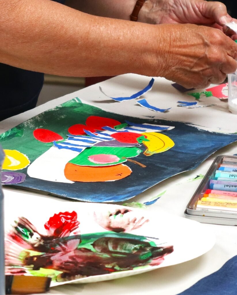 Art workshop in progress, collage fruit bowl inspired by Matisse, cancer charity providing creative respite in Dorset