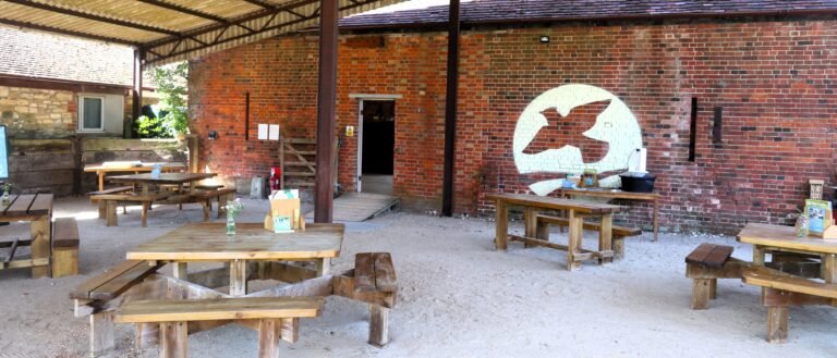 Exterior view of the Threshing Barn at Bere Marsh Farm, taken from the Buzz cafe seating area.